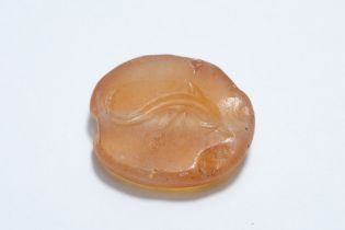 A Greek Carnelian Scarab Gem Depicting a Dolphin. 