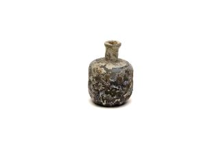 An Islamic Light Green Heavy Glass Bottle with Lovely Patina from the 11-12th Century.

H: Approxima