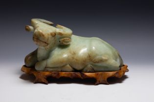 A Chinese Large Jade Figure of a Buffalo with a Wooden Stand.

H: Approximately 19cm
L: Approximatel
