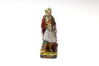 An Islamic Porcelain Figure of a Turkish Man from the 19th Century with Character Marks to the Base.