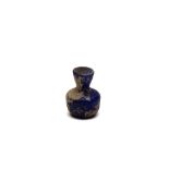 An Islamic Blue Glass with Nice Patina from the 11-12th Century.

H: Approximately 5.5cm 