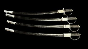 Four Indian Cavalry Swords. In Black canvas sheaths. Blades 73cm in length, suffering with rust