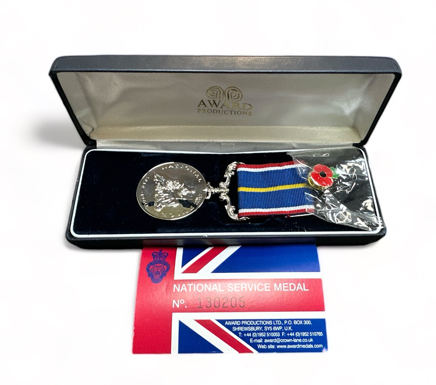 A boxed National Service medal to 5384452 SPR E. POWELL RE.