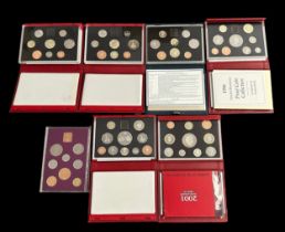 Collection of proof cased sets (7) with 1970, 1986, deluxe proof cased sets FDC 1994, 1995, 1996,