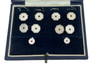 A cased octagonal white gold, mother of pearl and ruby cufflinks, button and studs set, S J Rose &