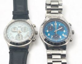 Two Swatch watches. A Swatch Irony quartz watch and a Swatch quartz watch with missing back. Both