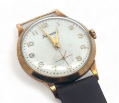 A 1950s Accurist 9ct gold gents manual wristwatch. Off-white dial with gold Arabic numerals and