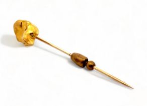A gold nugget pin. Nugget tested using XRF as 24ct gold, pin tests as 9ct gold. Length 56mm, 5.