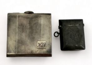 A silver compact and silver vesta case. Silver compact with engine turned decoration and monogram to