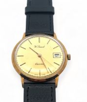 A H. Samuel 9ct gold gents wristwatch. Gold toned dial with baton hour markers and date display.