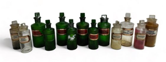13 Apothecary Jars: Seven green jars with fluted sides and chisel stoppers, 3 are 21cm x 8cm, one is