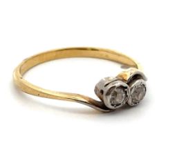 A diamond crossover ring, set in unmarked yellow metal, tests as 18ct gold using XRF. Size Q.