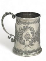 A Victorian repousse silver tankard by H & S, Edinburgh, 1873. 9cm high. Inscribed on base '