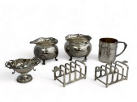 A selection of silver and white metal items. Includes a pair of hallmarked four piece toast racks by