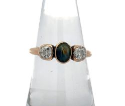 A sapphire and diamond three stone ring. Central oval cut sapphire of approx 6mm x 4.5mm is