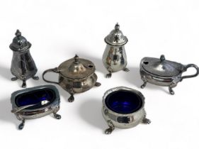Six silver salts, four with blue glass linings and a small silver spoon. Total silver weight 287g.