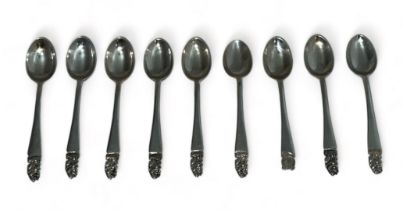 Set of eight hallmarked silver Warwick spoons with the top of each spoon featuring the