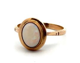 A gold and opal ring, stamped 9ct. Size O/P. Opal 9mm x 7mm and showing all colours of the