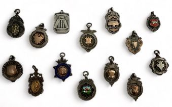 A collection of silver watch fob pendants / medals etc. Mostly dating from 1920s/ 1930s. Qty 14.