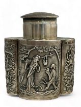 A Chinese export silver tea caddy in a quatrefoil form with lid, decorated with repousse scenes of