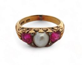 A ruby and pearl ring in an 18ct gold scroll setting, size I. Weight 5.4g. Signs of resizing/ repair