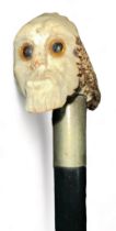 Ebonised walking Stick with antler handle depicting a skeletal head on one end of the handle.
