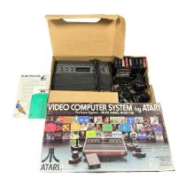Atari CX-2600 console in good original box, with paperwork, 2x joystick, 2x paddle controllers, 1x