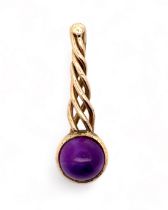 An amethyst cabochon pendant set in unmarked yellow metal (tests as 9ct using XRF). Pendant length