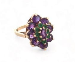 An amethyst and emerald cluster ring set in 9ct yellow gold, size K.