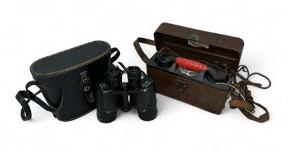 A field telephone in case and wooden box and a cased pair of Welmy binoculars.