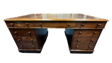 A Victorian double pedestal mahogany partners desk, circa 1860, with tooled red leather writing