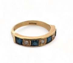 An 18ct gold, diamond and synthetic sapphire seven stone ring, size N. Weight 4.48g.