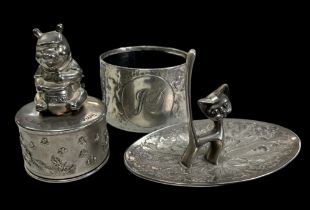 Collection of three silver plated items. A Seba ring holder in the style of a cat. A silver Winnie