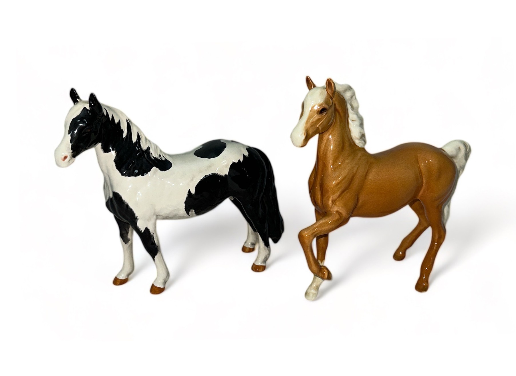 Beswick, pair of figures to include; Beswick Piebald Pinto Pony and Beswick Palomino trotting horse.