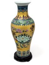 A large Chinese vase on a rotating wooden base, height approx. 45cm.