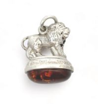 A sterling silver and amber fob pendant formed in the shape of a lion. Birmingham 1907 hallmarks.