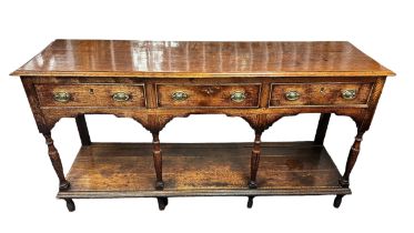 A late 18th or early 19th Century three drawer oak pot board dresser base, w156cm x d42cm x h81cm.