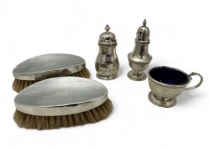An assortment of hallmarked silver items including a pair of silver brushes, Birmingham, 1958, a