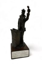 ‘ The Auctioneer ‘ bronze trophy, sculpture modelled as an Auctioneer at the rostrum stood on a