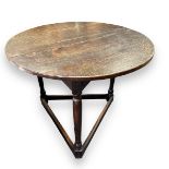 18th Century oak cricket table, having a planked top on ring turned supports, united by low square
