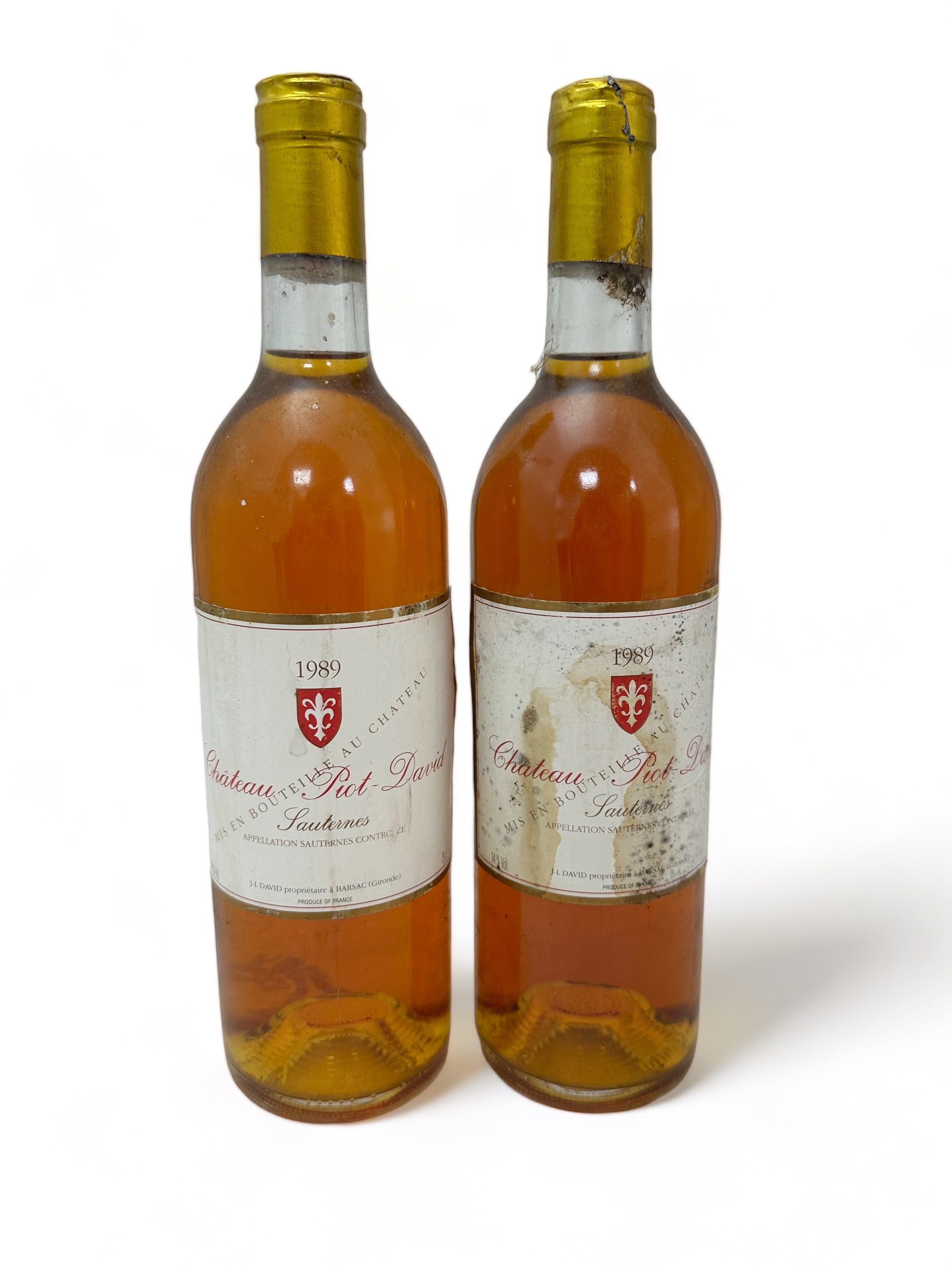 Two bottles of dessert wine Chateau Piot-David Sauternes 1989, 2e Grand Cru Classé. Damage to