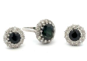 A dark green sapphire and diamond ring and matching earrings. Unmarked metal tests as 18ct white