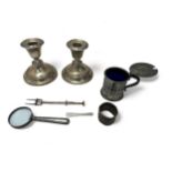 A range of silver and white metal items: includes a weighted pair of candle holders with marks for