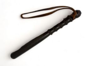 An unmarked truncheon with brown leather strap. 39cm in length.