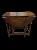 A late 17th Century oak gateleg table. Height 64cm, width 71cm, depth 37cm opening to 83cm.