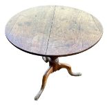 Early 19th Century oak tripod table. Diameter 70cm, h 69cm.