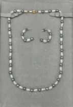 A freshwater pearl necklace comprising of alternate rice krispie and black pearls and a clasp