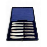 A cased set of six butter knives with EPNS blades and filled silver handles. Hallmarks for William