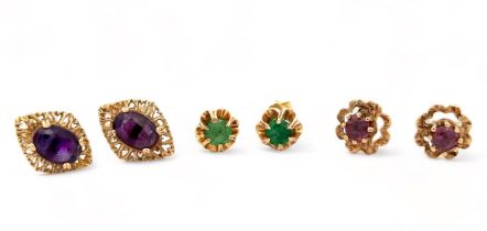 Three pairs of stud earrings, including a pair of amethyst earrings, a pair of emerld earrings and a