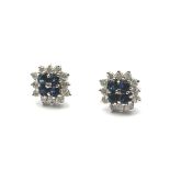 A pair of sapphire and diamond cluster earrings, stamped 750. Weight 3g.